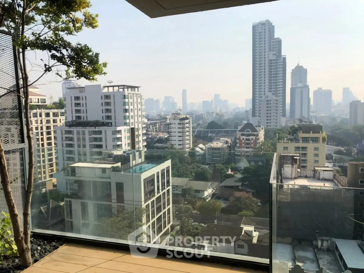 Stunning cityscape view from a modern balcony in a high-rise building.