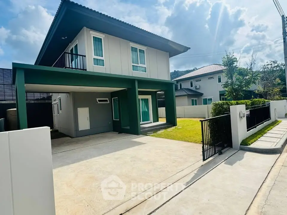Modern two-story house with spacious driveway and lush green lawn under a clear blue sky.