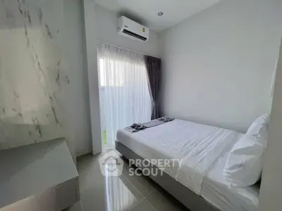 Modern minimalist bedroom with air conditioning and natural light