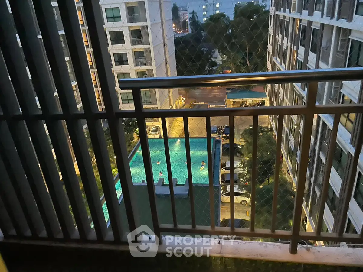 Stunning high-rise view of a pool from a balcony, perfect for urban living.