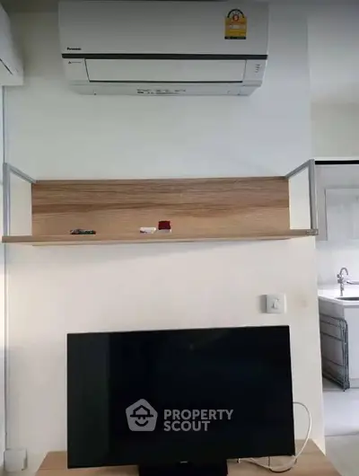 Modern interior with air conditioning and TV setup in a cozy living space.