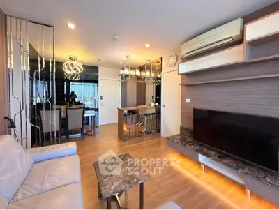 Modern open-plan living room with stylish lighting and sleek flooring.