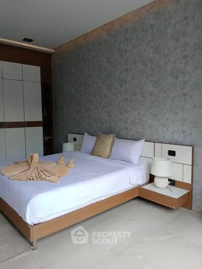 Modern bedroom with stylish decor and elegant furnishings, featuring a cozy bed and contemporary design.
