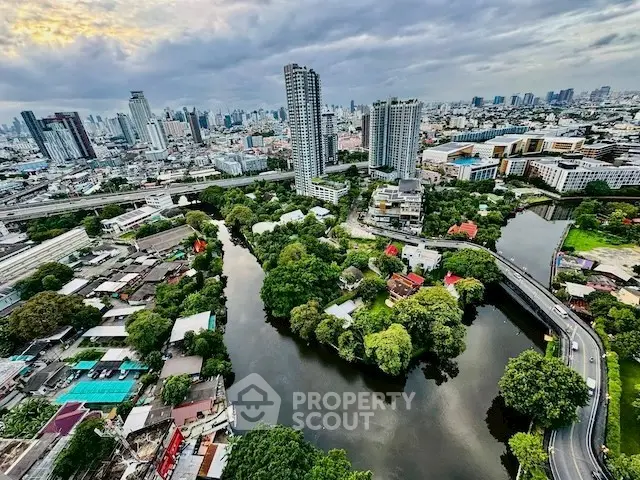Stunning aerial view of urban landscape with river and skyscrapers, perfect for city living enthusiasts.