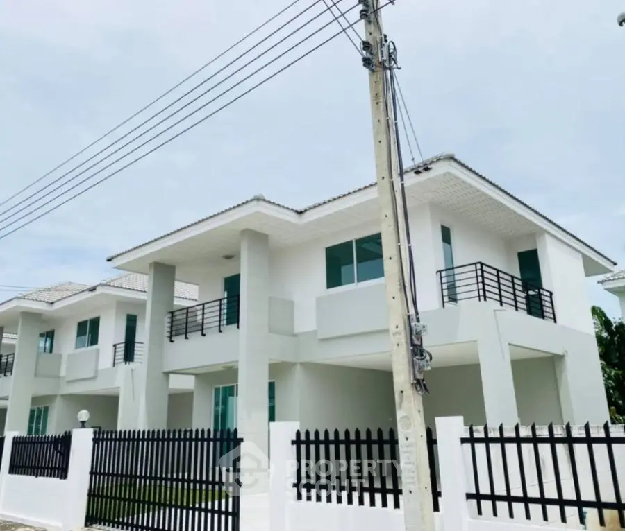 Modern two-story house with sleek design and spacious balconies in a serene neighborhood.