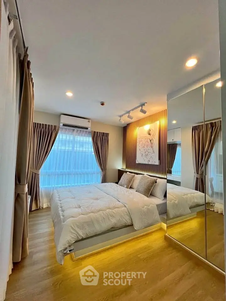 Luxurious bedroom with modern decor and large mirrored wardrobe