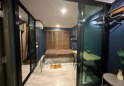 Modern studio apartment with glass partitions and cozy workspace