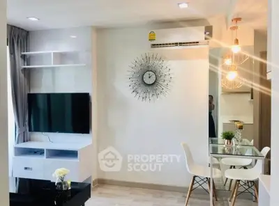 Modern living room with stylish decor and dining area, featuring a wall-mounted TV and elegant lighting.