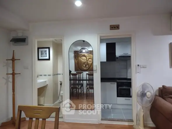 Charming apartment interior with modern kitchen and unique decor elements.