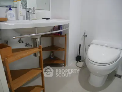 Modern bathroom with sleek fixtures and wooden shelving