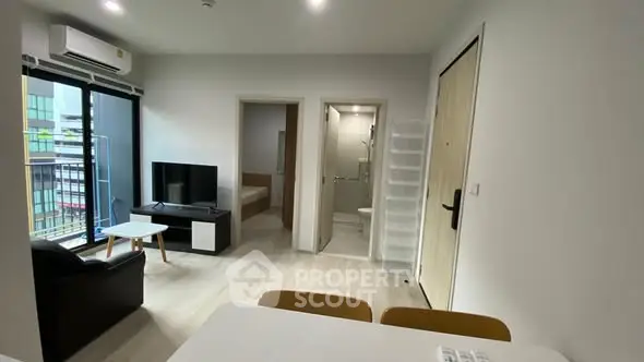 Modern apartment interior with open living area and balcony view.