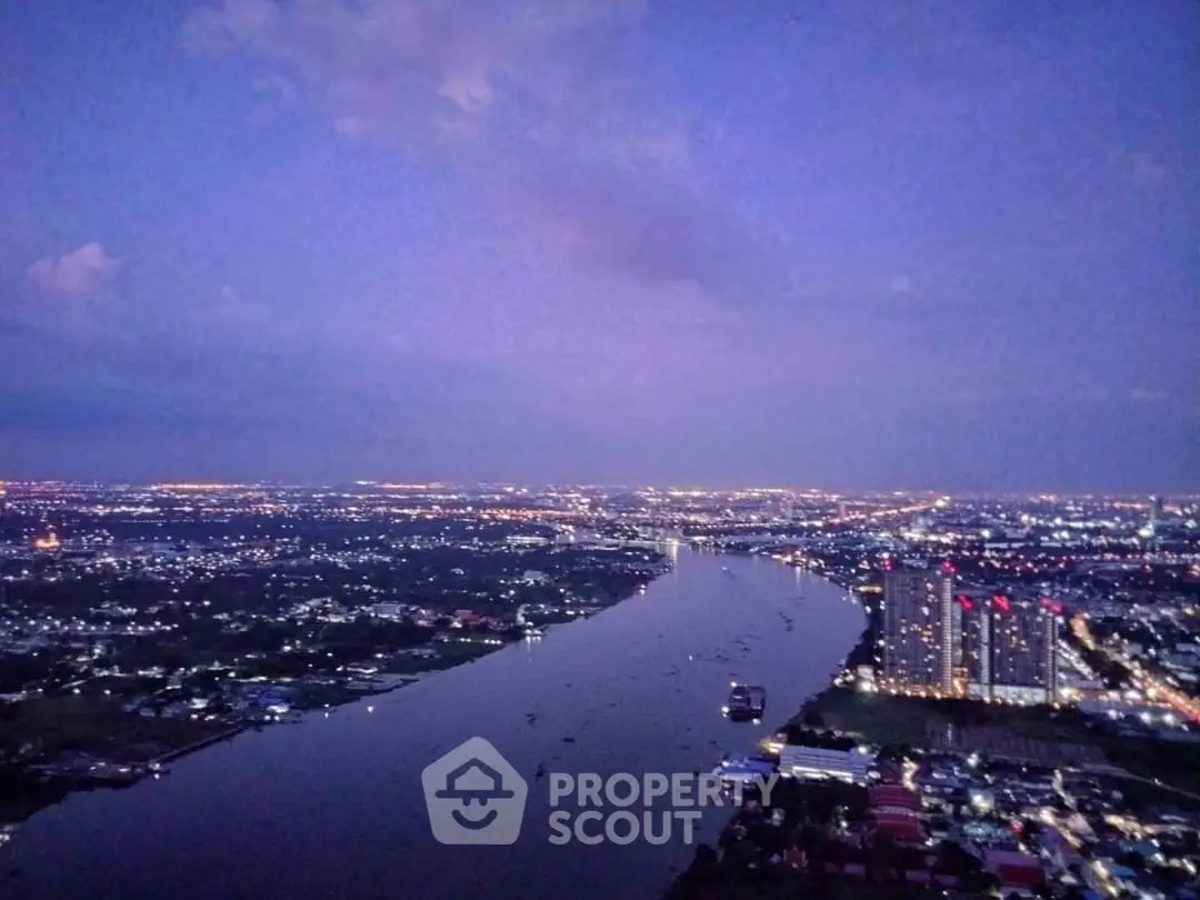 Stunning cityscape view with river and illuminated skyline at dusk