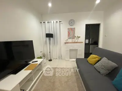 Cozy living room with modern decor and large TV