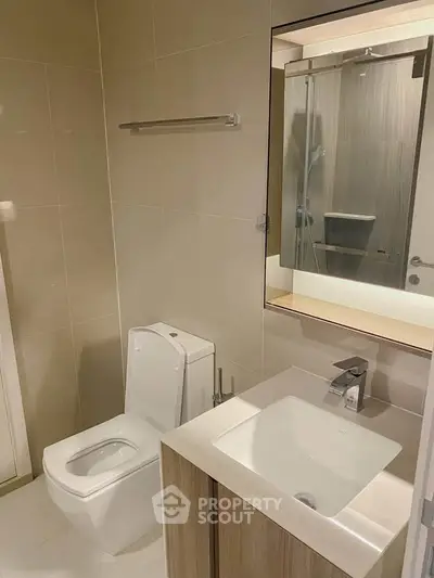 Modern bathroom with sleek fixtures and elegant design in a contemporary apartment.