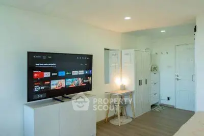 Modern living room with TV and cozy workspace in stylish apartment