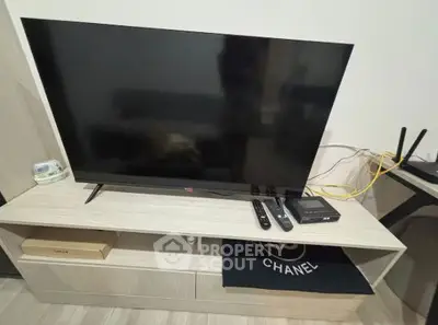 Modern living room setup with sleek TV and entertainment unit, perfect for cozy evenings.