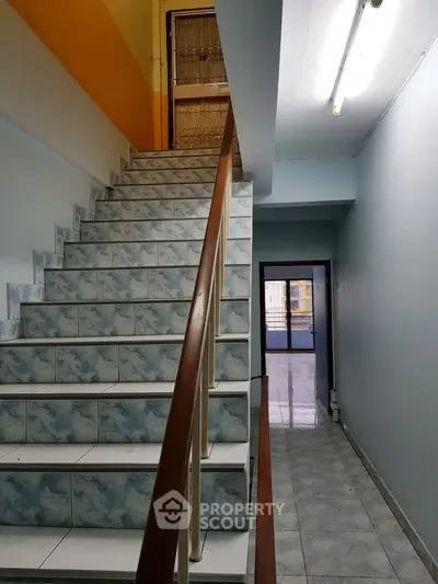 Charming stairway leading to a bright balcony in a cozy home