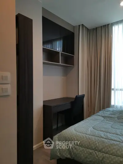 Cozy bedroom with study desk and large window for natural light