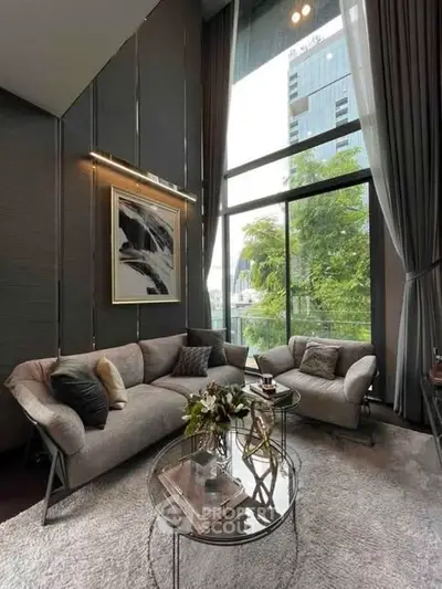 Luxurious living room with high ceilings and large windows offering a stunning view, modern furniture and elegant decor.