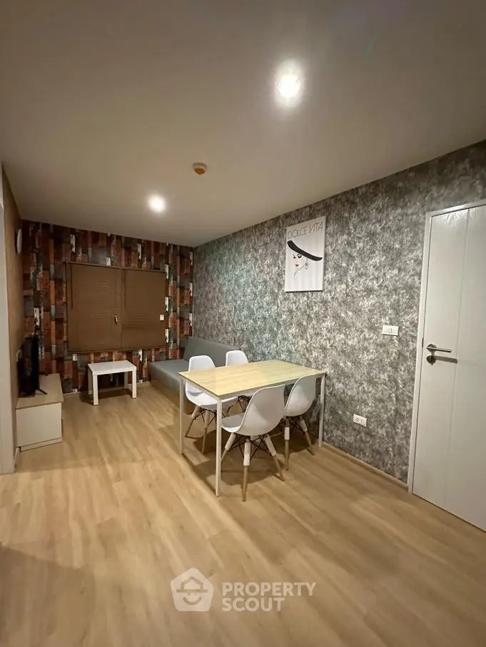 Modern living room with stylish decor and wooden flooring, featuring a dining area and cozy ambiance.