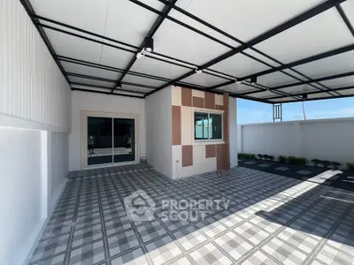 Modern covered patio with stylish tile flooring and sleek design, perfect for outdoor relaxation.