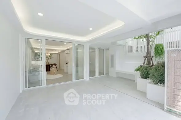 Spacious modern interior with sliding glass doors and elegant lighting