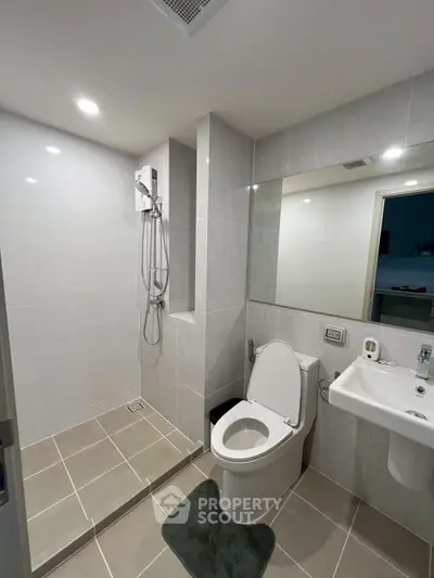 Modern bathroom with sleek fixtures and spacious shower area