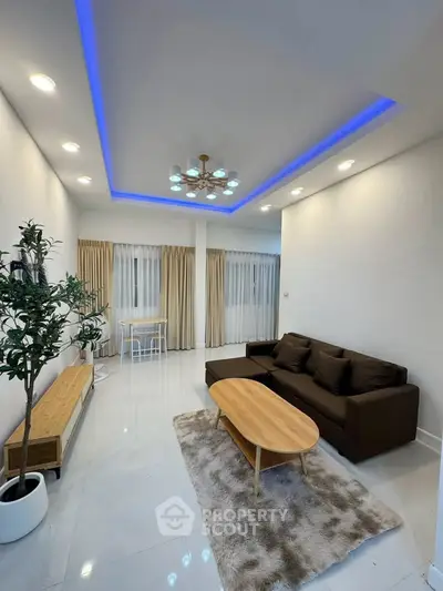 Modern living room with stylish lighting and cozy furniture, perfect for relaxation and entertainment.