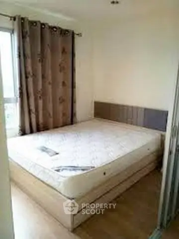 Cozy bedroom with natural light and modern decor, perfect for relaxation and comfort.