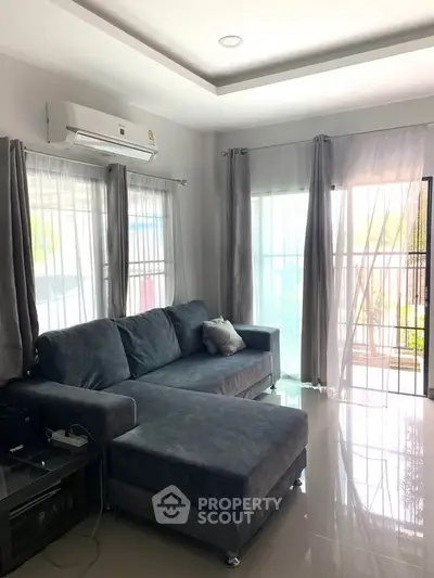 Modern living room with sleek gray sofa and natural light