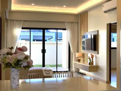 Modern living room with stylish decor, large windows, and elegant lighting, perfect for relaxation and entertainment.