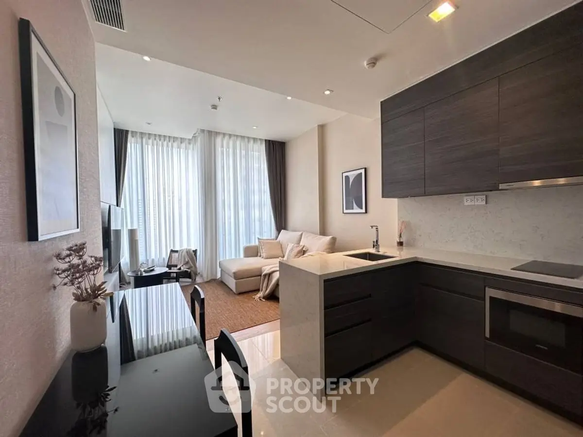 Modern open-plan living room and kitchen with sleek design and natural light