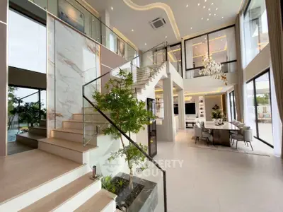 Luxurious modern living room with elegant staircase and open dining area