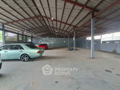 Spacious covered parking area with ample space for multiple vehicles.