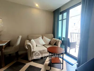 Cozy living room with elegant sofa and balcony access in modern apartment.