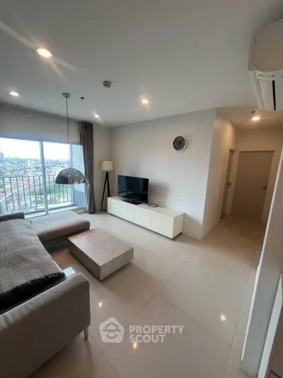 Modern living room with sleek furniture and city view from large window