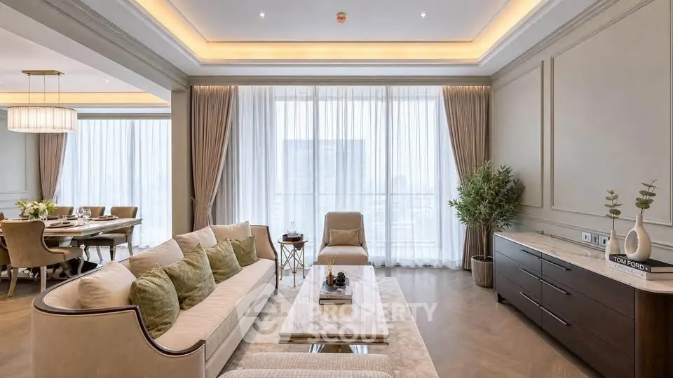Luxurious living room with elegant decor and dining area, featuring large windows and stylish furniture.