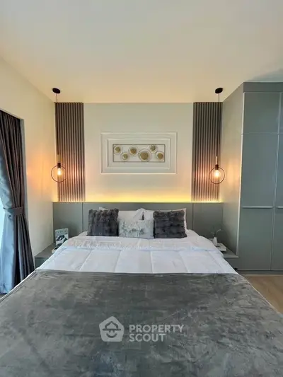 Luxurious bedroom with modern decor and ambient lighting, featuring plush bedding and stylish wall art.