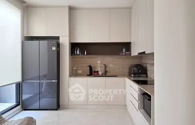 Modern kitchen with sleek cabinetry and built-in appliances in a bright, minimalist design.