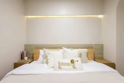 Cozy bedroom with modern lighting and stylish decor