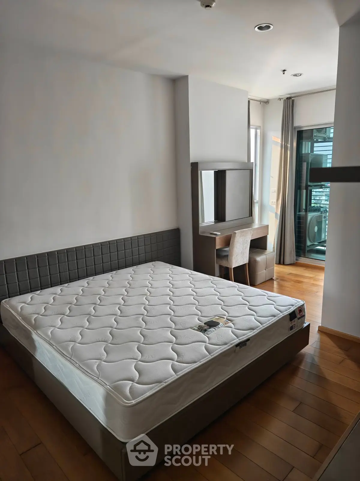 Modern bedroom with balcony access and stylish furniture in a contemporary apartment.