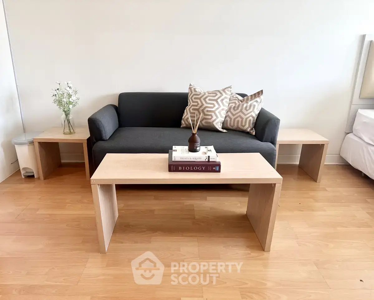 Modern living room with stylish sofa and wooden coffee table, perfect for cozy relaxation.