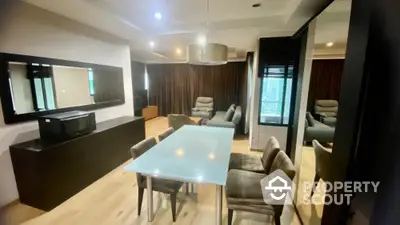 Spacious modern living room with elegant dining set, plush seating, and sleek entertainment unit, perfect for urban living.