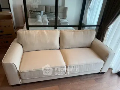 Elegant living room with beige sofa and mirrored wall, perfect for modern interiors.