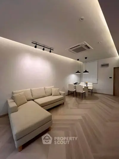 Modern living room with stylish lighting and cozy beige sectional sofa