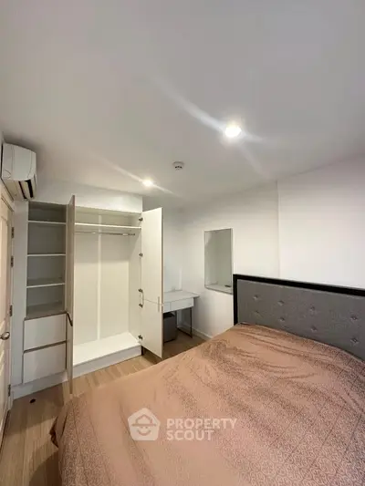 Modern bedroom with open wardrobe and cozy bed in a stylish apartment