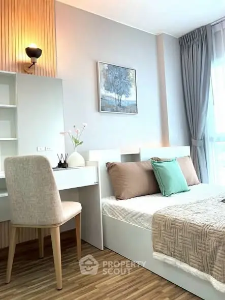 Modern bedroom with stylish decor and natural light, featuring a cozy bed and elegant furnishings.