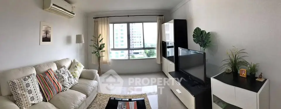 Spacious living room with modern decor and large window view