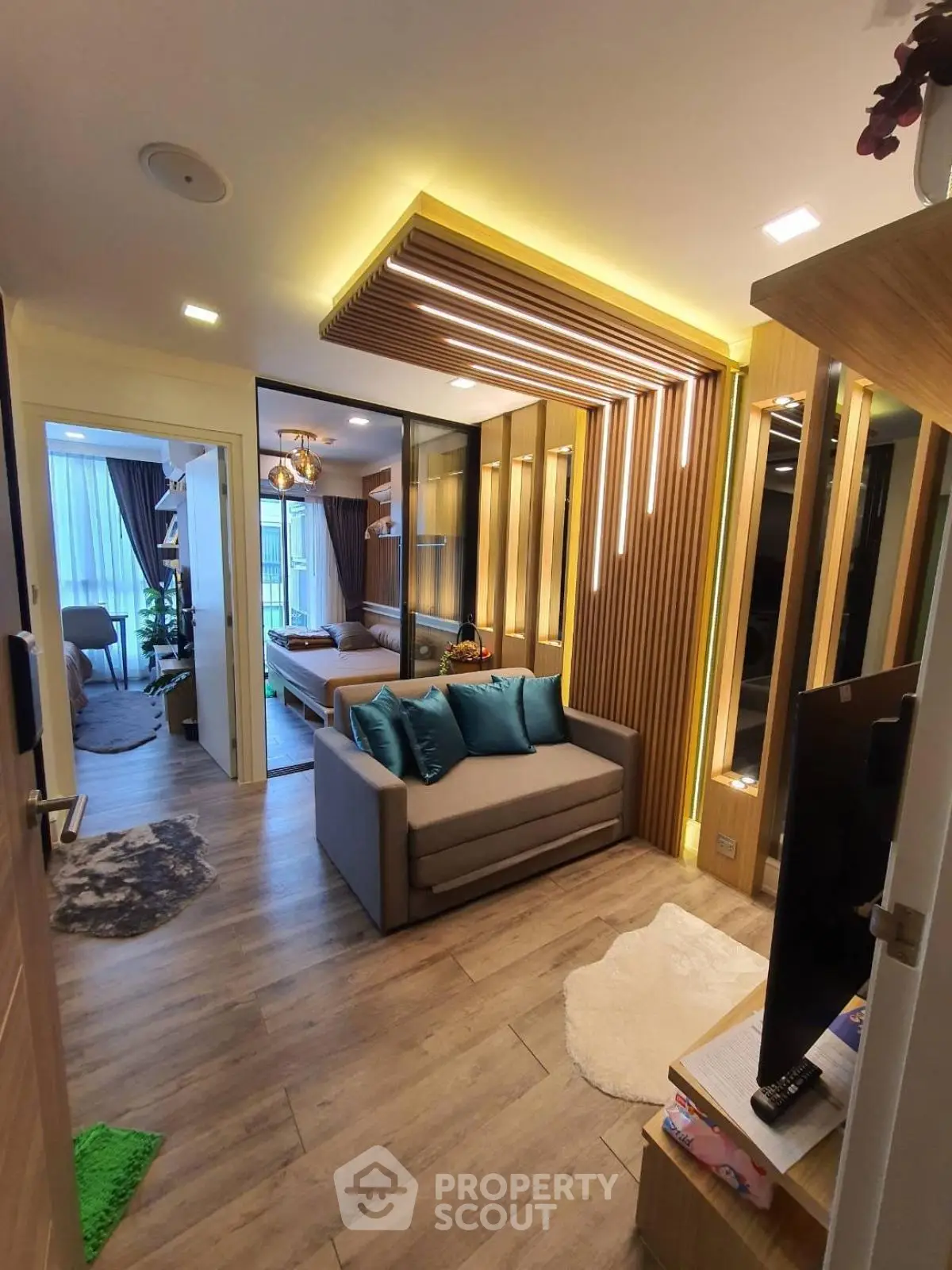 Modern living room with stylish lighting and cozy seating in a contemporary apartment.