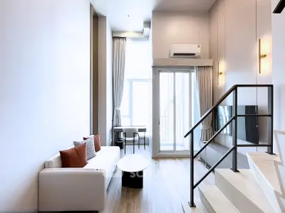 Modern duplex living room with high ceilings and stylish decor